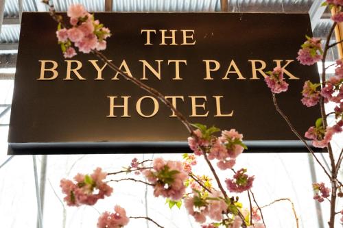 a sign for the elephant park hotel with pink flowers at Bryant Park Hotel in New York
