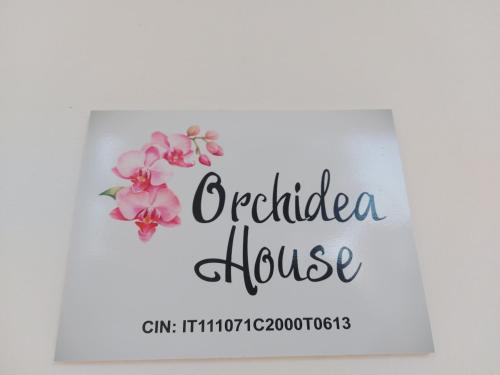 a sign for a bridal house with pink flowers at Orchidea House in SantʼAntìoco