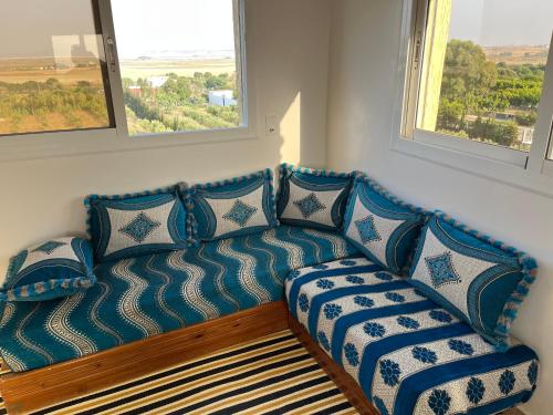 a blue couch in a room with two windows at Penthouse Armonía in Briech