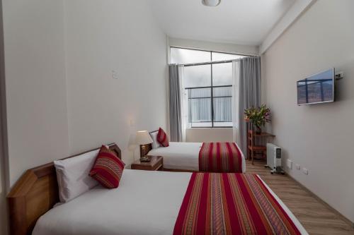 Postel nebo postele na pokoji v ubytování Quechua Plaza Hotel