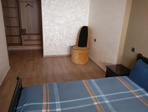 a bedroom with a bed with a speaker on the wall at للا ربيعة بيتي in Kenitra