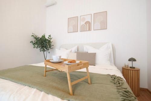 a bed with a wooden coffee table on it at Apartment Grace Royal in Vienna