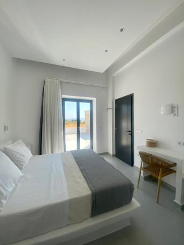 a bedroom with a bed and a desk and a window at GBR 2 - Golden Beach Residences in Chrissi Akti