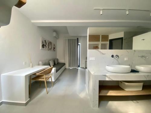 a white bathroom with two sinks and a large mirror at GBR 2 - Golden Beach Residences in Chrissi Akti