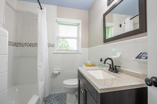 a bathroom with a sink and a toilet and a mirror at Comfort & Space in Prime Cartersville Spot in Cartersville