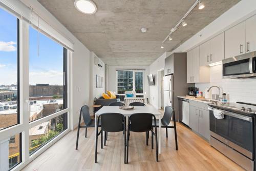 a kitchen and dining room with a table and chairs at 2BR City Escape Bright Sleek Spacious in Chicago