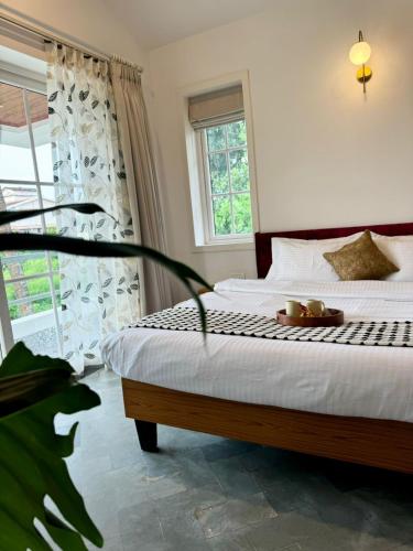 a bedroom with a bed with a plate of food on it at Sun-kissed Holidays, Goa - Copper in Serula