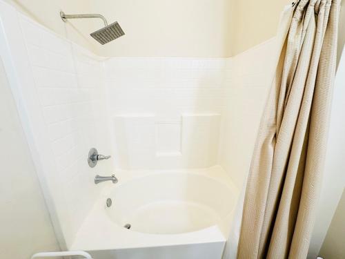 a white bathroom with a toilet and a shower at Chateau 8 in Hammond