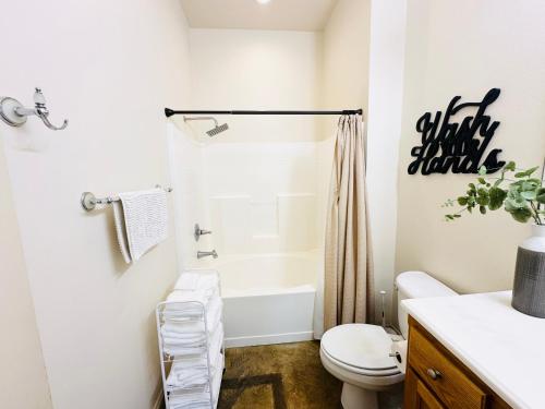 a bathroom with a white toilet and a shower at Chateau 8 in Hammond