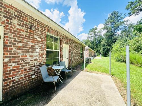 a brick building with two chairs and a table at Chateau 8 in Hammond