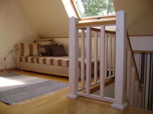 a attic bedroom with a bed and a window at Mere Holiday House in Salme