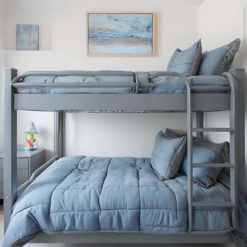a bedroom with two bunk beds with blue pillows at Riverside Stay in Niagara Falls