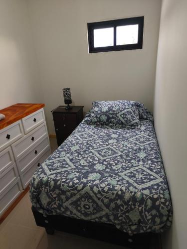 a bedroom with a bed and a dresser at Loftdonalejandro in Machalí