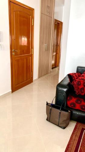 a black leather couch sitting in a living room at M'Diq Minute Walk-1st Floor in M'diq