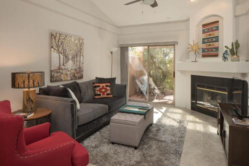 a living room with a couch and a fireplace at Elegant and updated - In the heart of Sedona in Sedona
