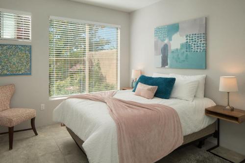 a bedroom with a bed and a chair and a window at Elegant and updated - In the heart of Sedona in Sedona