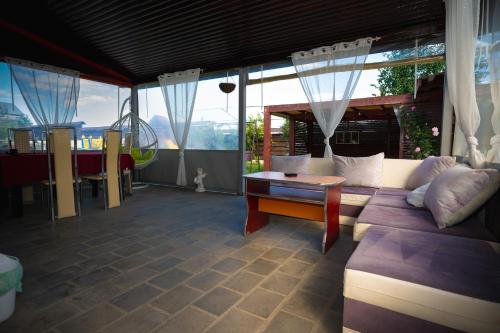 a living room with a couch and a table at Vila Medana in Humuleşti