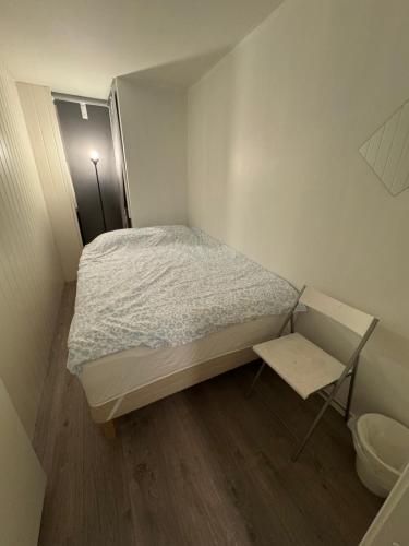 a small bedroom with a bed and a table at Guesthouse Platina centrum in Oslo