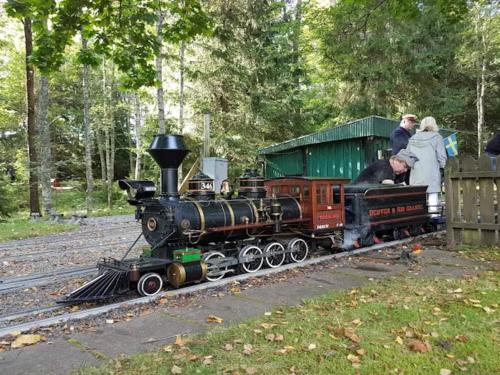 a small train on the tracks with people on it at 4 person holiday home in BORÅS in Borås