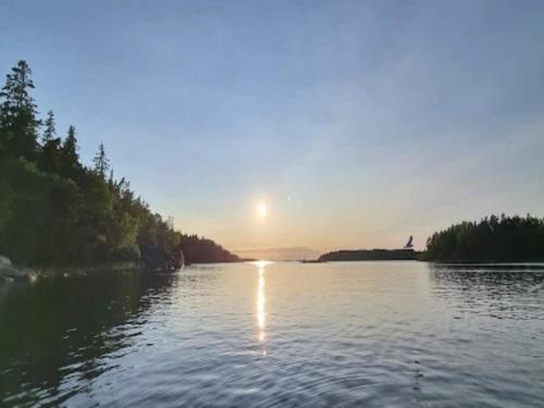 a view of a river with the sun setting at 7 person holiday home in GRISSLEHAMN-By Traum in Grisslehamn