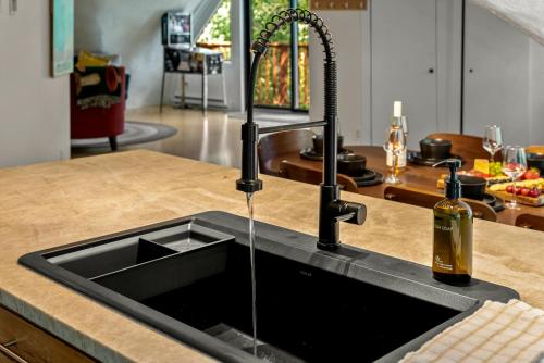 a kitchen counter with a sink with a bottle of wine at The Iconic Vail Ski Dome, Free parking for skiers! in Vail