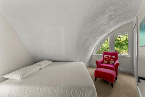 a bedroom with a bed and a red chair at The Iconic Vail Ski Dome, Free parking for skiers! in Vail