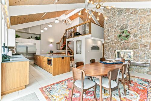 a kitchen and dining room with a wooden table and chairs at Artful Stay, Downtown, Spacious, LED Art, Hot Tub in Denver