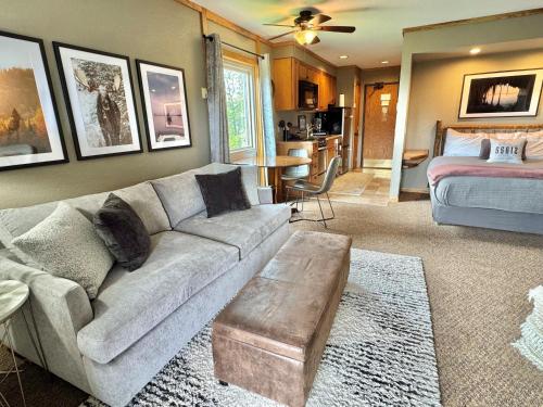 a living room with a couch and a bed at Ski in Ski out Cozy Studio Condo, Pool, Hot Tub, Views of Moose Mtn in Lutsen