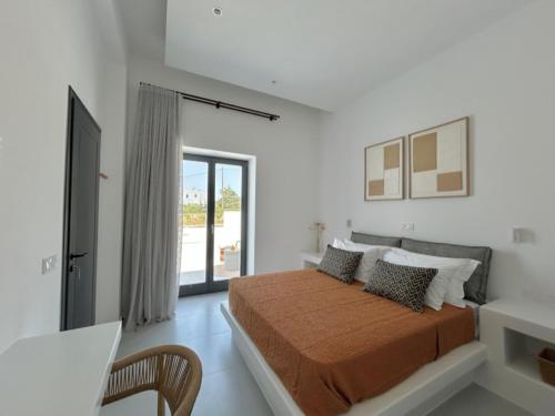 a bedroom with a bed in a white room at GBR 1 - Golden Beach Residences in Chrissi Akti