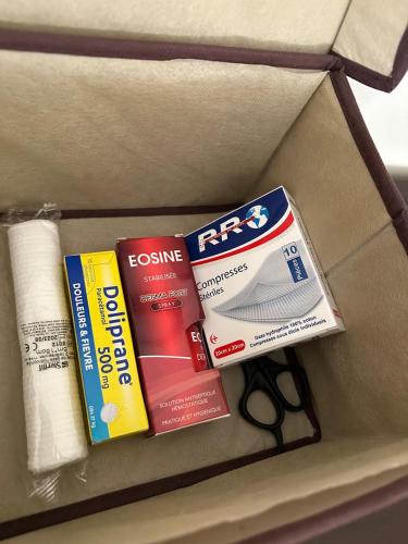 a box with books and a pair of scissors at Apprt 2min de la Gare,Wi-Fi Fibre, Netflix ,PS4 in Settat