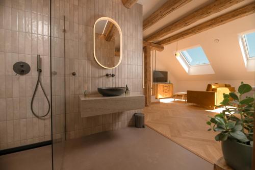 a bathroom with a sink and a mirror at 1779 SUITES Kežmarok in Kežmarok