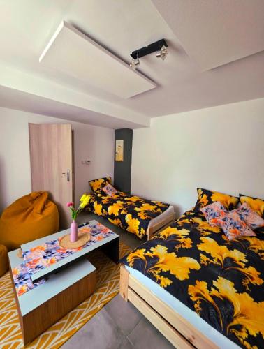 a bedroom with a bed and a table in it at Apartament słoneczny in Rydułtowy