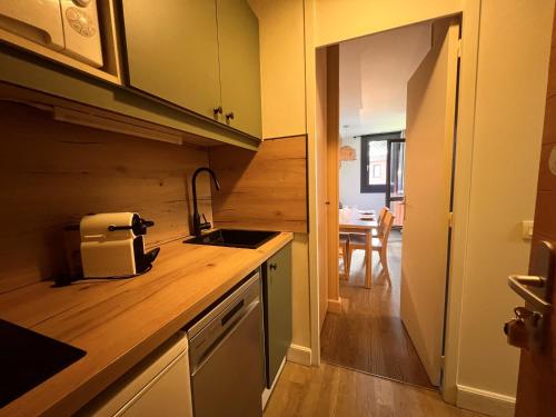 a kitchen with a sink and a counter top at Appartement lumineux avec balcon et parking in La Plagne Tarentaise