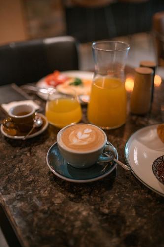 a table with a cup of coffee and a plate of food at 1779 SUITES Kežmarok in Kežmarok