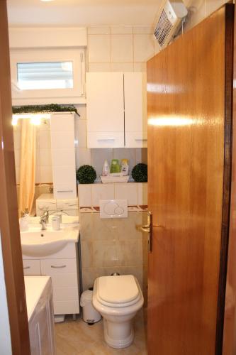 a small bathroom with a toilet and a sink at Apartment Meli Varazdin in Varaždin