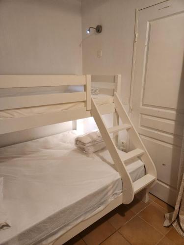 a white bunk bed in a room at Restanques appartement vue mer in Grimaud
