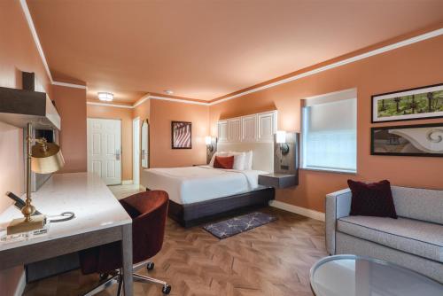 a hotel room with a bed and a desk at The Inn at Lewisburg, BW Signature Collection in Lewisburg