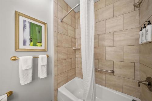 a bathroom with a shower and a tub and a toilet at The Inn at Lewisburg, BW Signature Collection in Lewisburg
