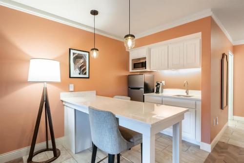 a kitchen with a white table and a lamp at The Inn at Lewisburg, BW Signature Collection in Lewisburg