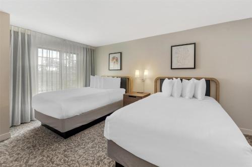 a hotel room with two beds and a window at Sonesta ES Suites Austin The Domain Area - Newly Renovated in Austin