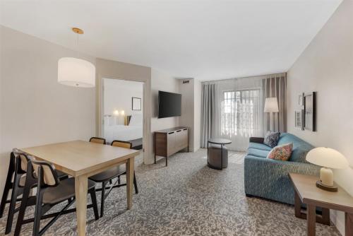 a living room with a blue couch and a table at Sonesta ES Suites Austin The Domain Area - Newly Renovated in Austin
