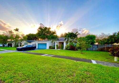 a house with a car parked in a yard at BEAUTIFUL POOL HOME 2 beds 1 Bath FT LAUDERDALE,MIAMI in Cooper City