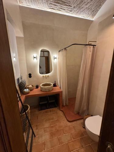 a bathroom with a sink and a toilet and a mirror at Villa Duna Maria in Fuzeta