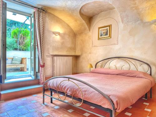 a bedroom with a bed in a room with a window at ' La Tavernetta ' del Principe in Oulx