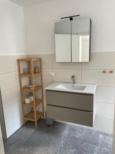a bathroom with a sink and a mirror at Black Forest apartment in Rottweil in Rottweil