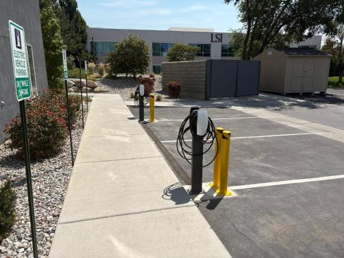 a parking lot with parking meters in front of a building at Candlewood Suites - Layton - Salt Lake City by IHG in Layton