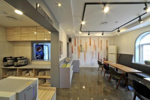 a kitchen and dining room with a table and chairs at S Hotel in Gwangju