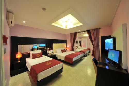 a hotel room with two beds and a flat screen tv at S Hotel in Gwangju
