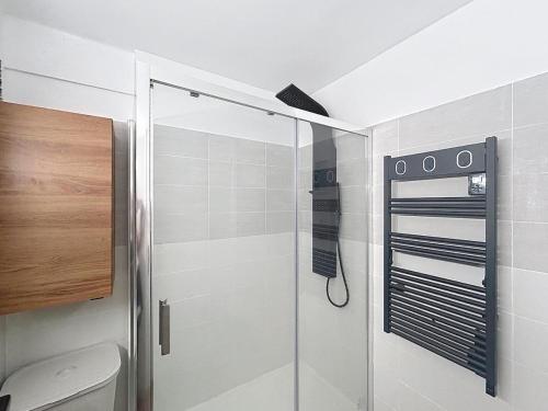 a shower with a glass door in a bathroom at Beautiful 4 rooms sea airport in Nice