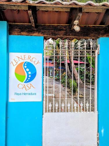 a sign on a gate in front of a building at Tropical Cabina Pool & AC Cozy Bright Refreshing in Herradura